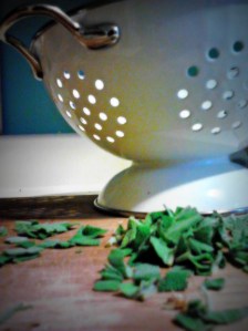Chopped sage and white collander